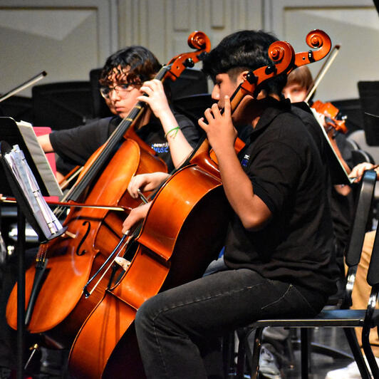 Orchestra members practice prior to the event. (Photo by Karidja Monjolo)